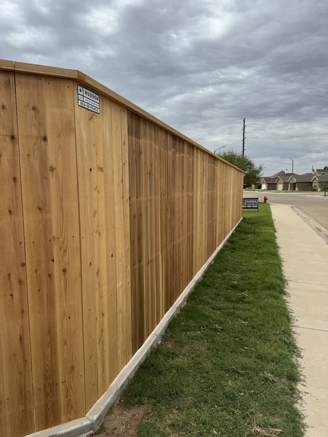 7 ft capped cedar privacy fence along a sidewalk in Lubbock, TX