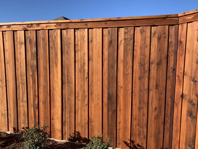 Stained 7 ft board-on-board cedar fence with a top cap built by Hudson Fence Company