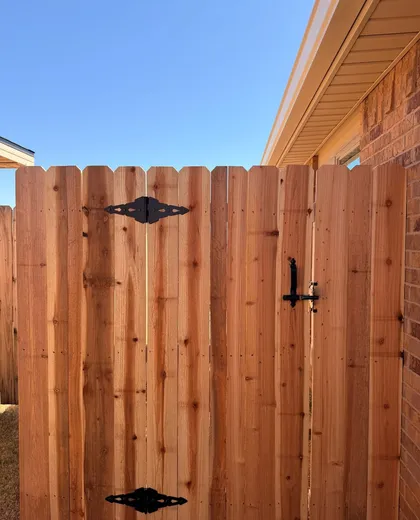 Dog ear cedar walk gate with black strap hinges and latch