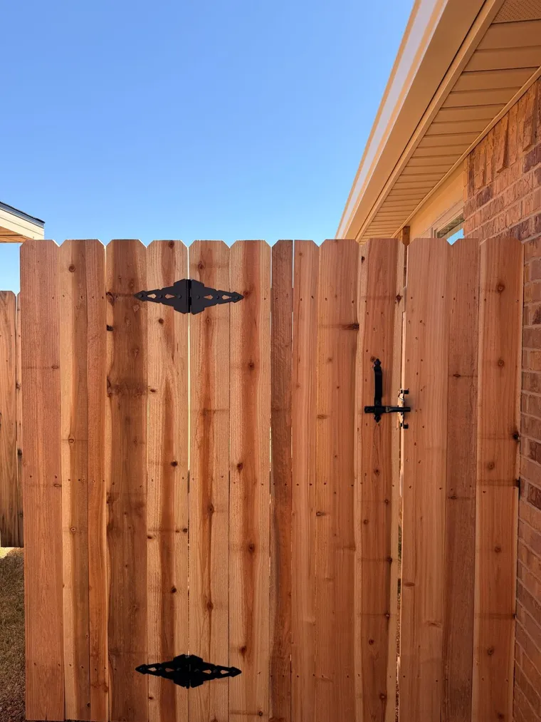 Dog ear cedar walk gate with black strap hinges and latch