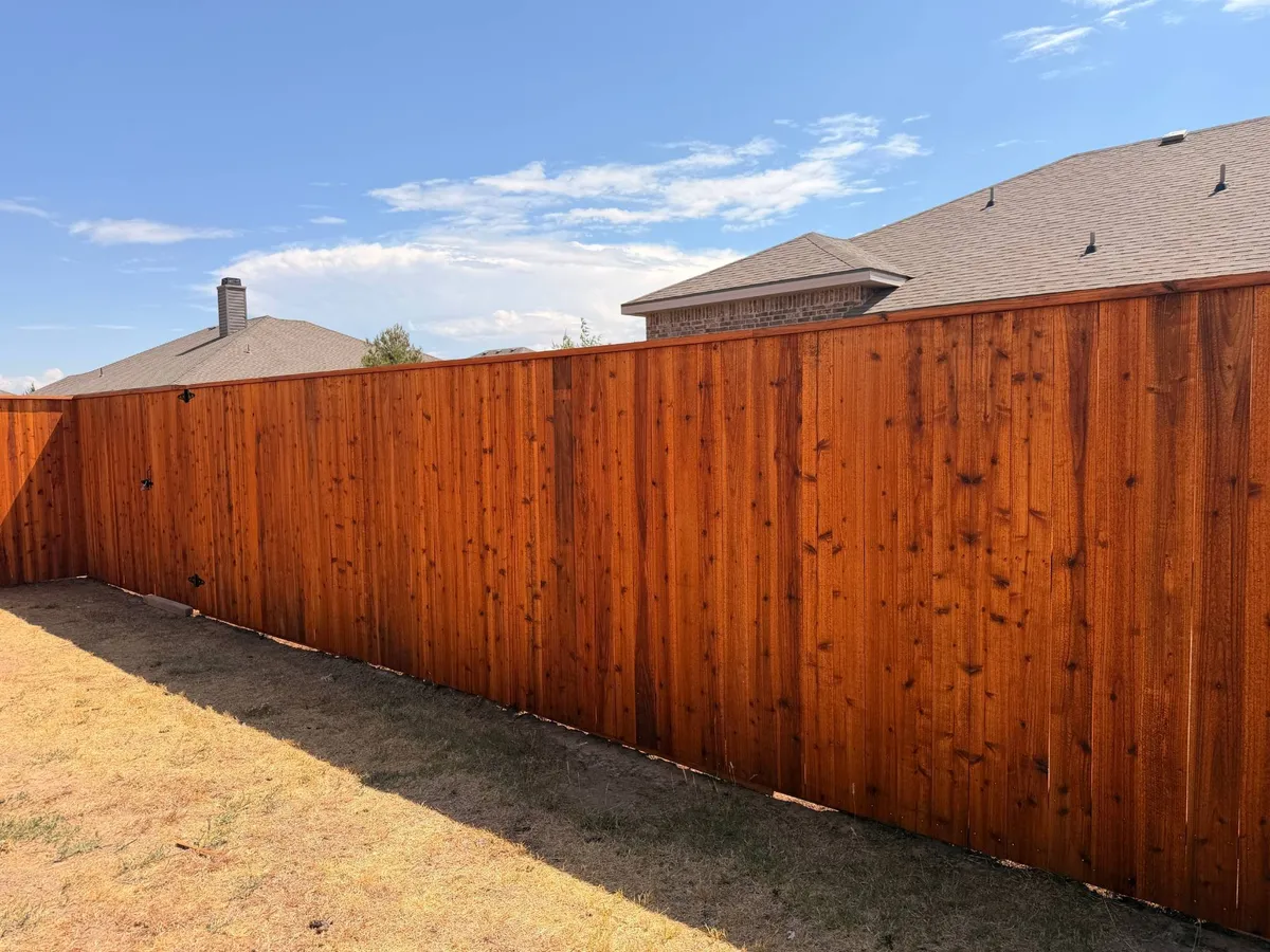 Long cedar privacy fence freshly stained in Cedar Tone by Hudson Fence Company in Lubbock, TX