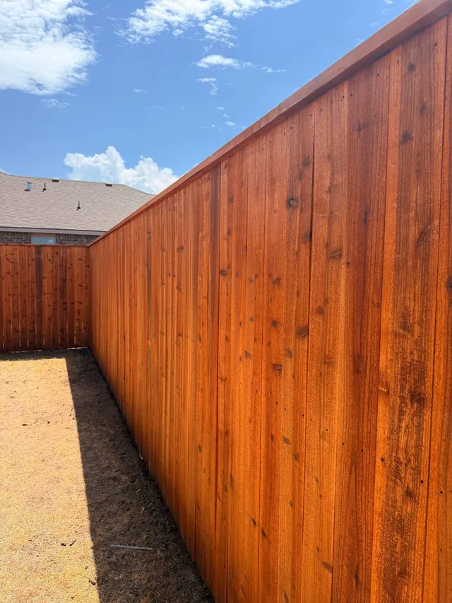 Cedar fence corner stained in Cedar Tone with the wood grain showing through