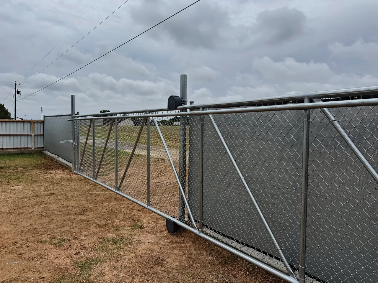 Galvanized chain link fence with a cantilever slide gate installed by Hudson Fence Company in Lubbock, TX