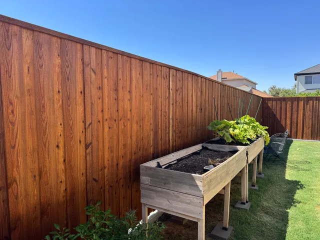 Backyard cedar fence stained with Wood Defender Leatherwood by Hudson Fence Company in Lubbock, TX