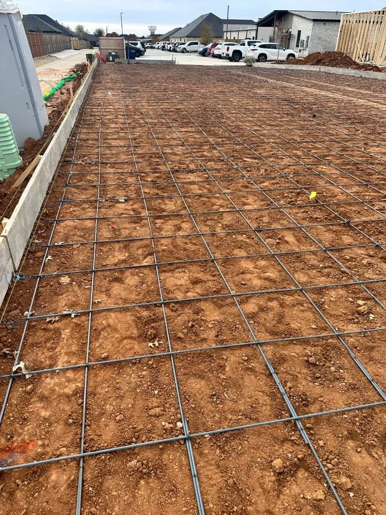 Rebar grid tied and set on grade before a large concrete pour